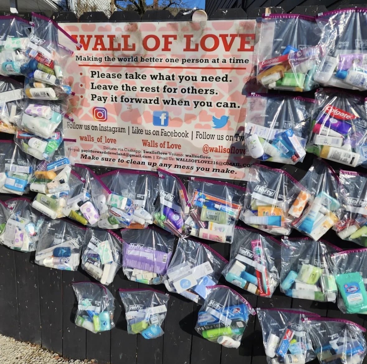 Wall of love with supplies on fence.