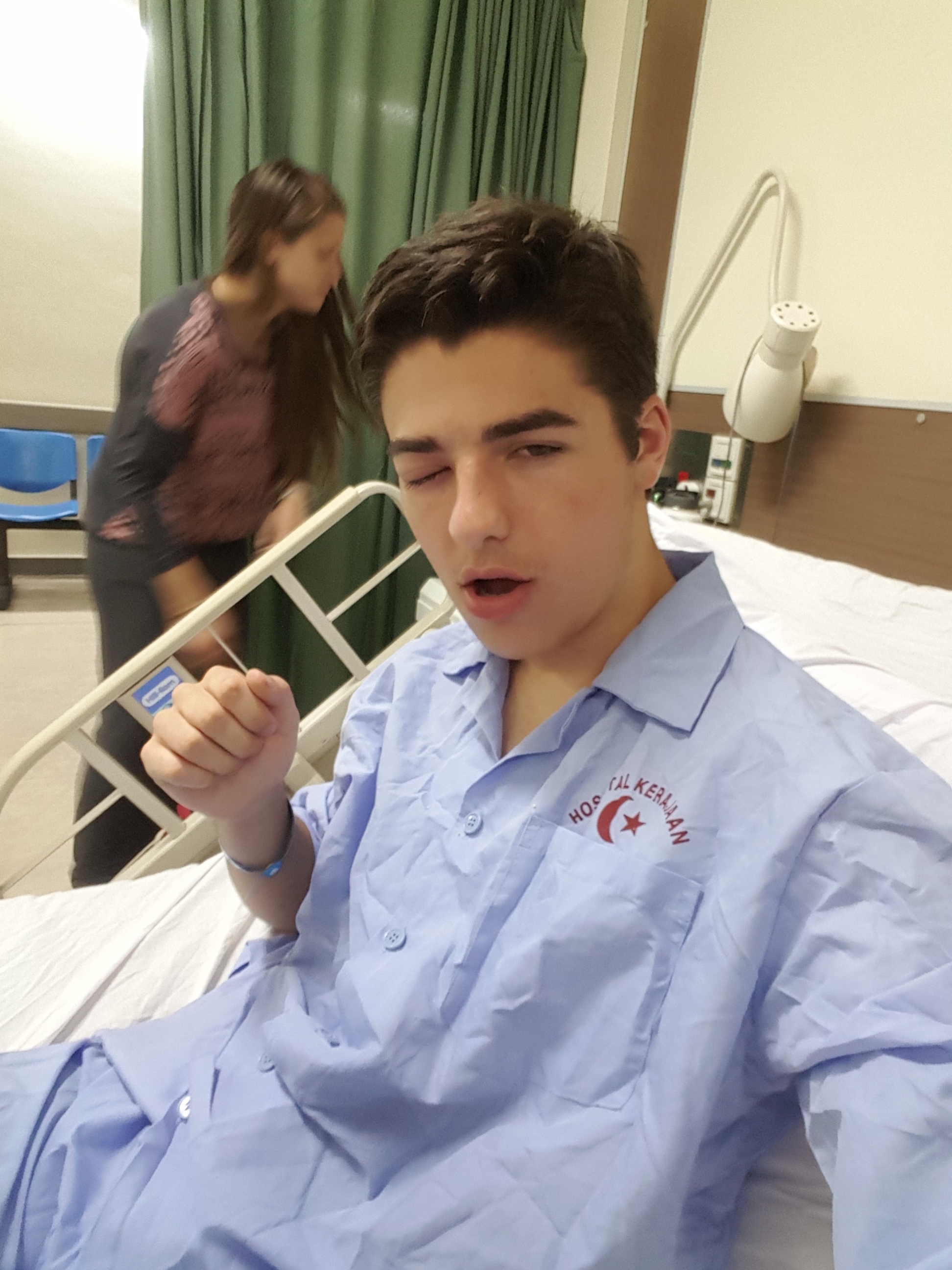 Ryan in the hospital in ThailandHilton taking a selfie after being admitted to the main hospital in Bandar Seri Begawan.