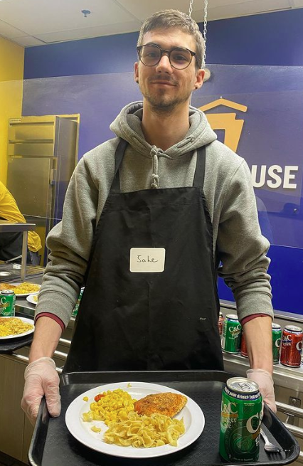 Eta Lambda Member holding meal 