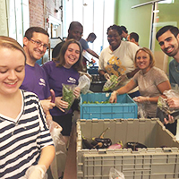 Omari with a group of volunteers