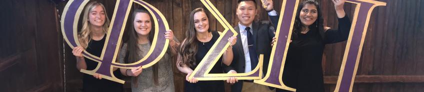 Thong Ta and other Phi Sigma Pi members holding Greek letters